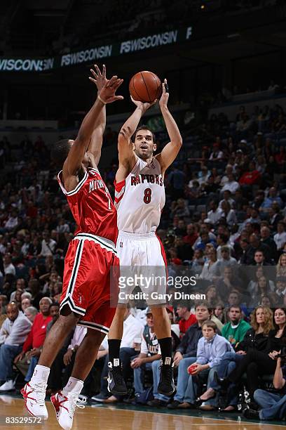 Jose Calderon of the Toronto Raptors shoots against Ramon Sessions of the Milwaukee Bucks on November 1, 2008 at the Bradley Center in Milwaukee,...