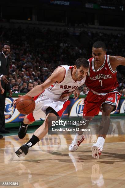 Jose Calderon of the Toronto Raptors drives to the basket against Ramon Sessions of the Milwaukee Bucks on November 1, 2008 at the Bradley Center in...