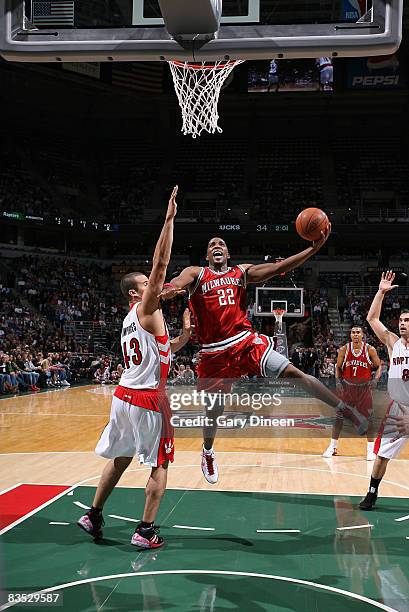 Michael Redd of the Milwaukee Bucks shoots a layup against Kris Humphries of the Toronto Raptors on November 1, 2008 at the Bradley Center in...