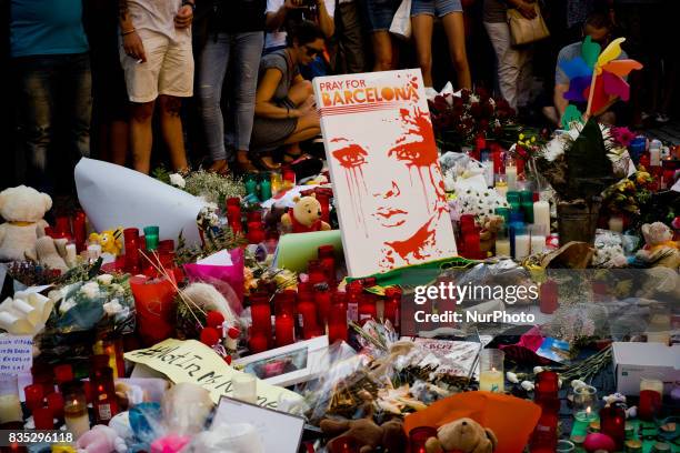 Flowers and candles stand in Las Ramblas of Barcelona, Spain, on 18 August 2017, to pay tribute to the victims a day after a van ploughed into the...