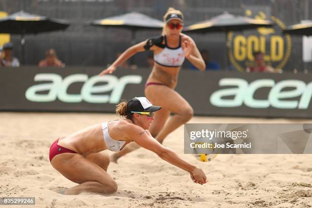 Lauren Fendrick digs the ball as April Ross runs in to set during their round 2 match at the AVP Manhattan Beach Open - Day 2 on August 18, 2017 in...