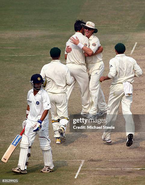 Gautam Gambhir of India walks off after being dismissed lbw by Mitchell Johnson with Brett Lee celebrating during day five of the Third Test match...