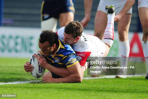 Leeds Rhinos' Jamie Jones-Buchanan goes over to score a try under pressure from St Helens' Matt Gidley during the Carnegie Challenge Cup match at...