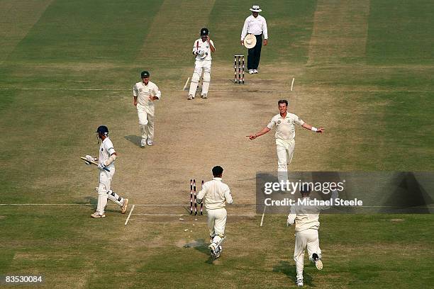 Brett Lee of Australia celebrates bowling Rahul Dravid during day five of the Third Test match between India and Australia at the Feroz Shah Kotla...