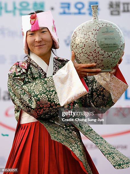 Candie Kung of Chinese Taipei lifts the winners trophy as she wears a South Korean traditional costume and crown during a ceremony following the Hana...