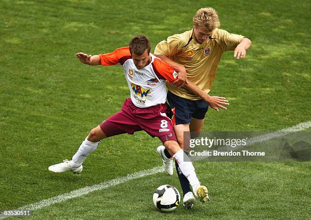 Michael Angus of the Roar competes with Jacob Pepper of the Jets during the round six National Youth League match between the Newcastle Jets and the...