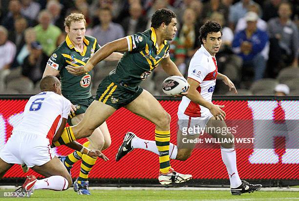 Greg Inglis beaks through the English defence to score Australia's second try in their Rugby League World Cup match at the Docklands Stadium in...