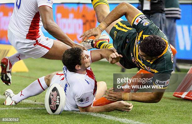 Australian player Greg Inglis scores his second try as England defender Paul Wellens pushes him out in their Rugby League World Cup match at the...