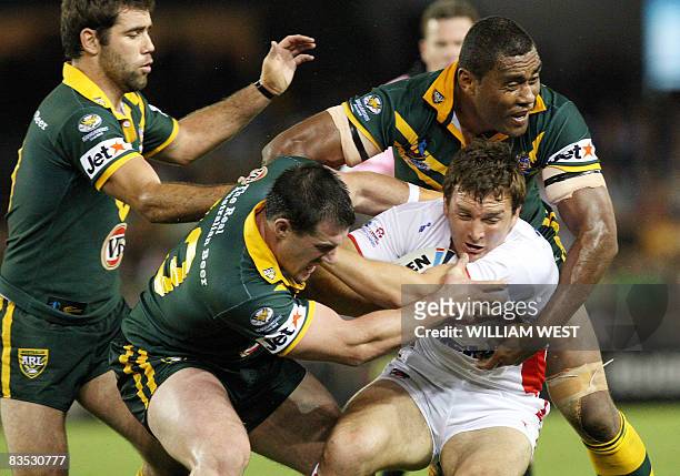 Martin Gleeson of England is tackled by Australia's Greg Inglis , Paul Gallen and Petero Civoniceva in their Rugby League World Cup match at the...