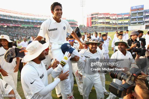 Indian captain Anil Kumble is chaired round the pitch on a lap of honour by his team mates after announcing his retirement from Test cricket during...