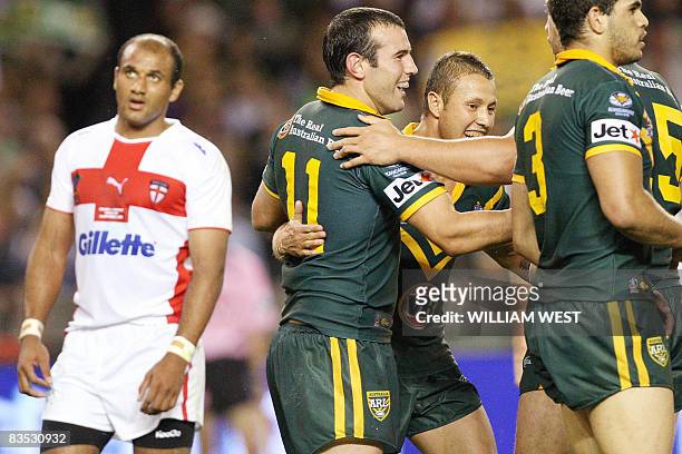 Australia's Glenn Stewart is congratulated by teammates after scoring a try against England in their Rugby League World Cup match at the Docklands...