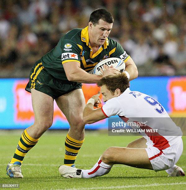 Australian player Paul Gallen pushes off the tackle of England defender James Roby in their Rugby League World Cup match at the Docklands Stadium in...