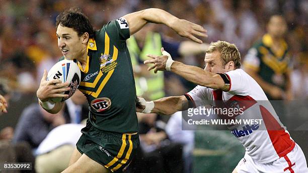 Australian player Billy Slater shrugs off the tackle of England defender Rob Burrow in their Rugby League World Cup match at the Docklands Stadium in...