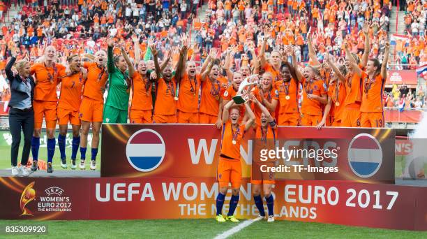 Mandy Van Den Berg and Sherida Spitse of Netherlands Women lift the trophy as their team mates celebrate after the UEFA Women's Euro 2017 final match...
