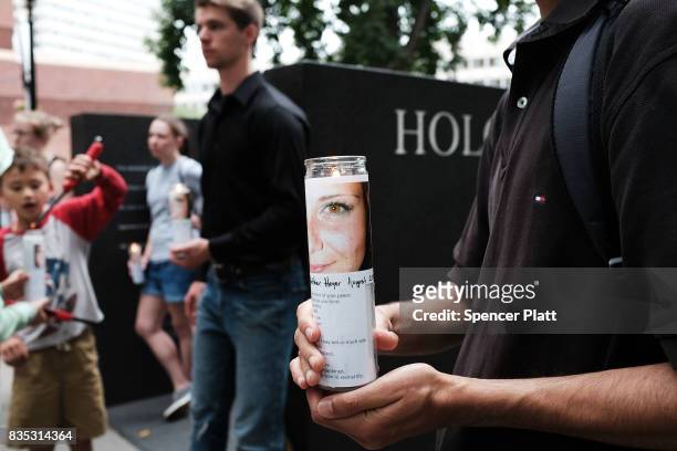 Candles are adroned with a picture of Heather Heyer at a vigil and march at the New England Holocaust Memorial to denounce hate groups before a...