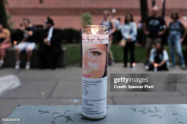 Candles are adorned with a picture of Heather Heyer at a vigil and march at the New England Holocaust Memorial to denounce hate groups before a...