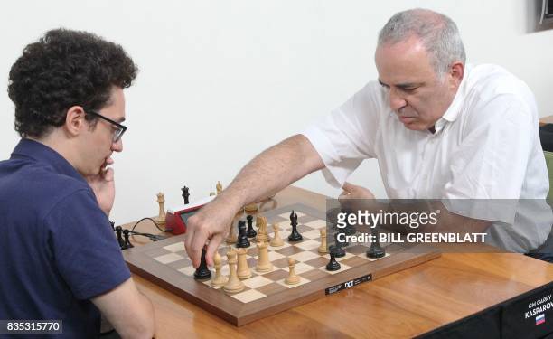 Grandmaster chess player Garry Kasparov makes a move, late in a match against grandmaster Fabiano Caruana during the final day of the Grand Chess...