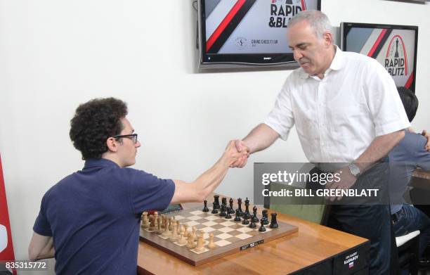 Grandmaster chess player Garry Kasparov shakes hands with grandmaster Fabiano Caruana during the final day of the Grand Chess Tour at the Chess Club...