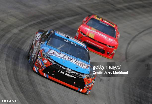 Kyle Busch, driver of the NOS Rowdy Toyota, leads Justin Allgaier, driver of the BRANDT Professional Agriculture Chevrolet, during the NASCAR XFINITY...