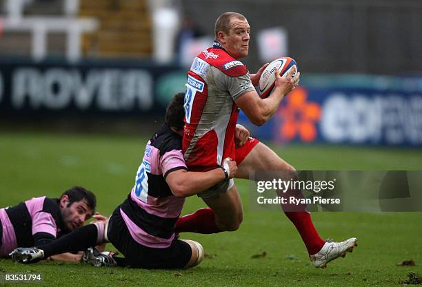 Mike Tindall of Gloucester is tackled by Phil Dowson of Newcastle during the EDF Energy Cup match between Newcastle Falcons and Gloucester at...