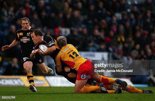Mark Van Gisbergen of Wasps is tackled by Ashley Smith of Newport Gwent Dragons during the EDF Energy Cup, Group A match between London Wasps and...