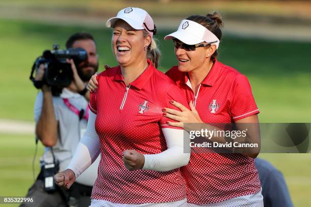 Brittany Lincicome and Brittany Lang of the United States Team celebrate after winning their match against Florentyna Parker and Caroline Masson of...