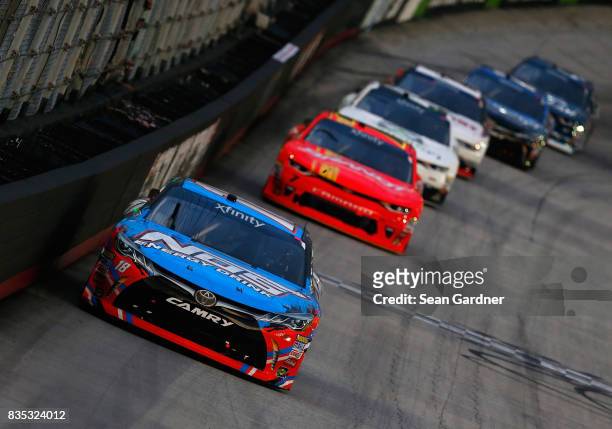 Kyle Busch, driver of the NOS Rowdy Toyota, leads a pack of cars during the NASCAR XFINITY Series Food City 300 at Bristol Motor Speedway on August...