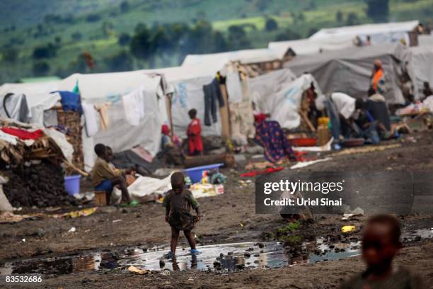 Congolese children play in the mud in an Internally Displaced People camp in Kibati towards Kibumba and Rugari on November 2, 2008 just North of...