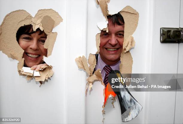 Green Euro Candidate Deirdre de Burca with Fianna Fail MEP Eoin Ryan peering through a smashed door that illustrates the smashing down of information...