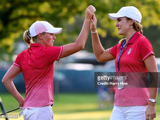 Stacy Lewis of Team USA celebrates a two and one victory over Team Europe with Lexi Thompson on the 17th green during the afternoon four-ball matches...