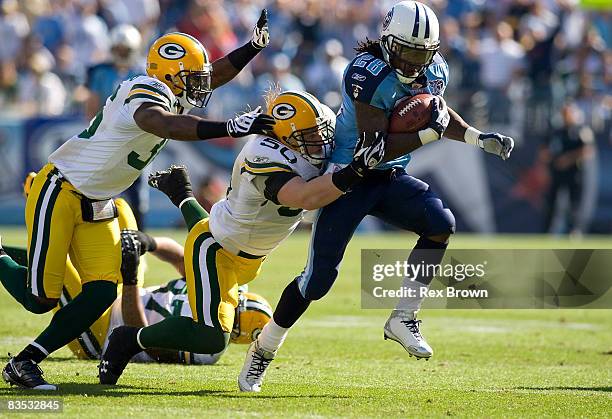 Chris Johnson of the Tennessee Titans is tackled by AJ Hawk and Nick Collins of the Green Bay Packers at LP Field on November 2, 2008 in Nashville,...