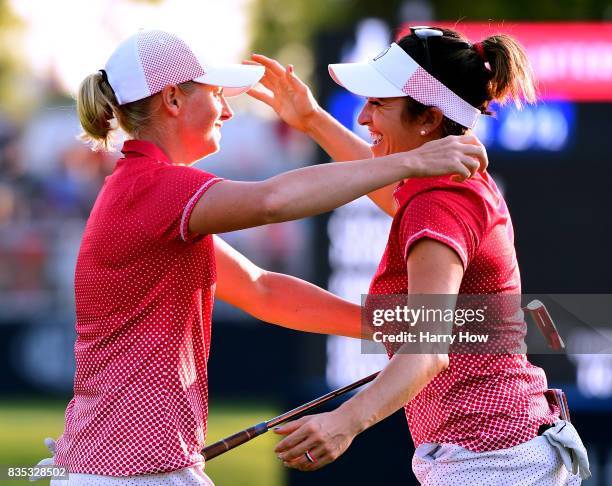 Stacy Lewis of Team USA celebrates a two and one victory over Team Europe with playing partner Gerina Piller on the 17th green during the afternoon...