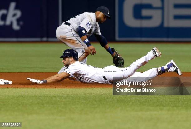 Kevin Kiermaier of the Tampa Bay Rays slides safely into second base ahead of second baseman Robinson Cano of the Seattle Mariners after hitting a...