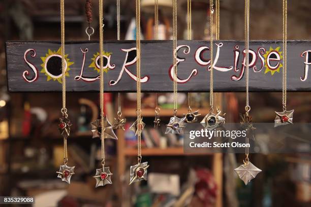 Solar eclipse jewelry by Dave Dardis is displayed at his Rainmaker art studio on August 18, 2017 in Makanda, Illinois. With approximately 2 minutes...