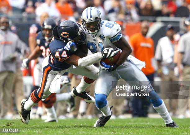 Wide receiver Calvin Johnson of the Detroit Lions makes a reception and is brought down by Kevin Payne of the Chicago Bears during the second quarter...