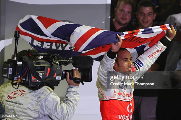 New Formula One World Champion Lewis Hamilton of Great Britain and McLaren Mercedes celebrates in parc ferme following the Brazilian Formula One...
