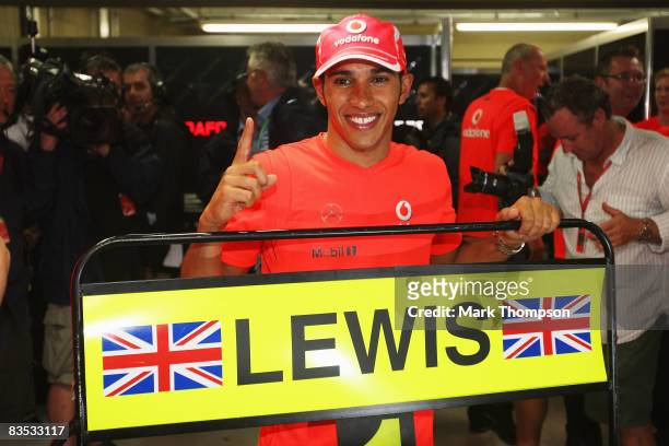 New Formula One World Champion Lewis Hamilton of Great Britain and McLaren Mercedes celebrates following the Brazilian Formula One Grand Prix at the...