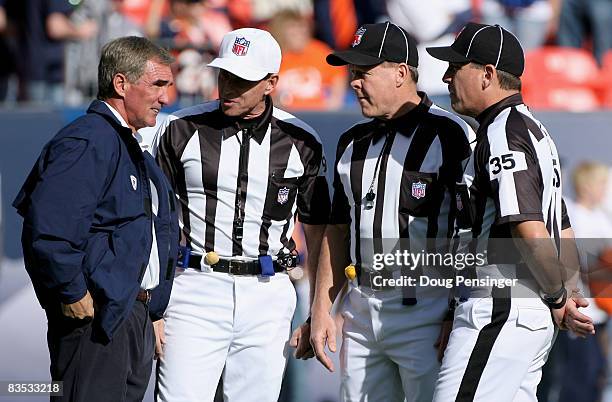 Head coach Mike Shanahan of the Denver Broncos chats with referee Tony Corrente, umpire Steve Wilson and line judge John Hussey prior to facing the...