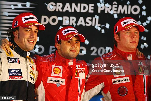 Felipe Massa of Brazil and Ferrari looks disappointed on the podium alongside second placed Fernando Alonso of Spain and Renault and third placed...