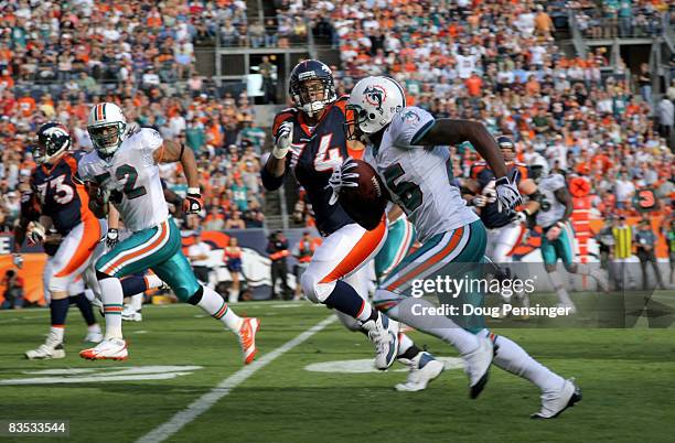 Cornerback Will Allen of the Miami Dolphins returns an interception of a pass by Jay Cutler of the Denver Broncos 32 yards for a first quarter...