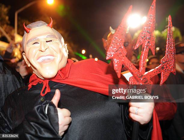 Man wearing a mask of US President George W. Bush attends the West Hollywood Halloween costume carnival, in West Hollywood, California, on October...