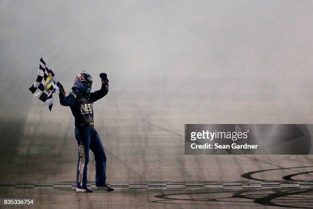 Kyle Busch, driver of the NOS Rowdy Toyota, celebrates with the checkered flag after winning the NASCAR XFINITY Series Food City 300 at Bristol Motor...