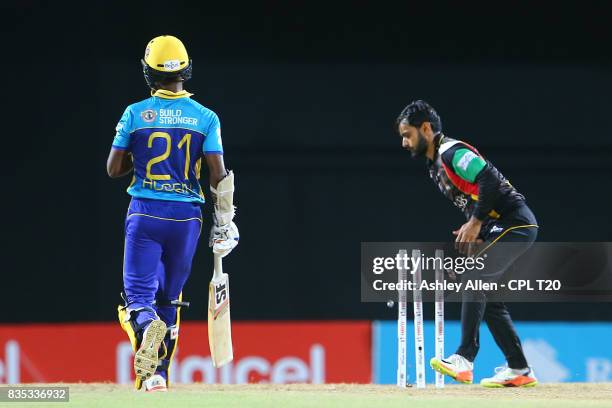 In this handout image provided by CPL T20, Mohammed Hafeez of St Kitts and Nevis Patriots takes the bails off to run out Akeal Hosein of the Barbados...