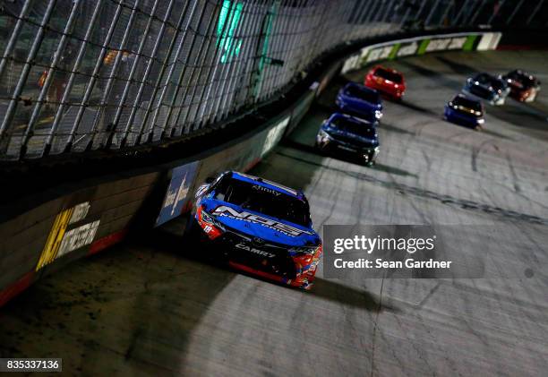 Kyle Busch, driver of the NOS Rowdy Toyota, leads a pack of cars during the NASCAR XFINITY Series Food City 300 at Bristol Motor Speedway on August...