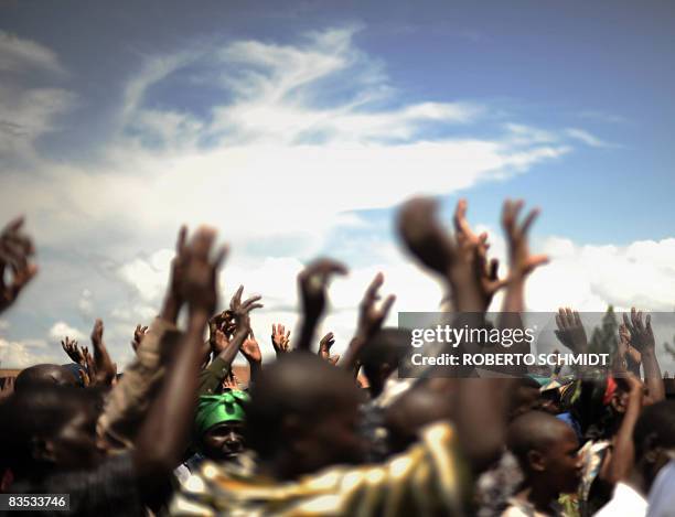 Residents of the town of Ruthshuru raise their hands as they acknowledge a local leader at the local stadium on November 01, 2008 in a ceremony where...