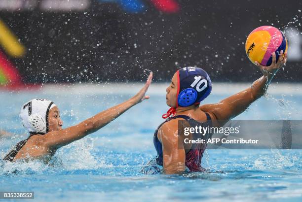 Singapore's Angeline Teo Yi Ling fights for posesssion of the ball against Thailand's Sarocha Rewrujirek during their women's water polo round match...