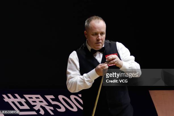 John Higgins of Scotland chalks the cue during his second round match against Tom Ford of England on day three of Evergrande 2017 World Snooker China...