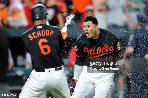 Manny Machado of the Baltimore Orioles celebrates with teammates after hitting the game winning grand slam in the ninth inning against the Los...