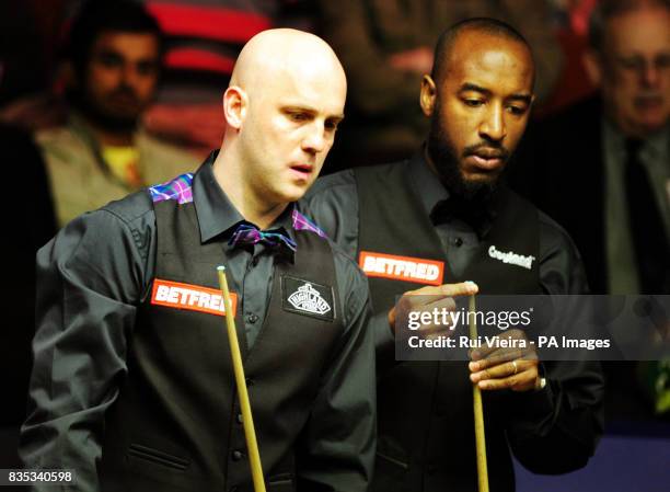 England's Mark King with England's Rory McLeod during the Betfred.com World Snooker Championship at The Crucible Theatre, Sheffield.