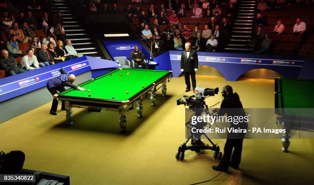 England's Rory McLeod watches England's Mark King in action during the Betfred.com World Snooker Championship at The Crucible Theatre, Sheffield.